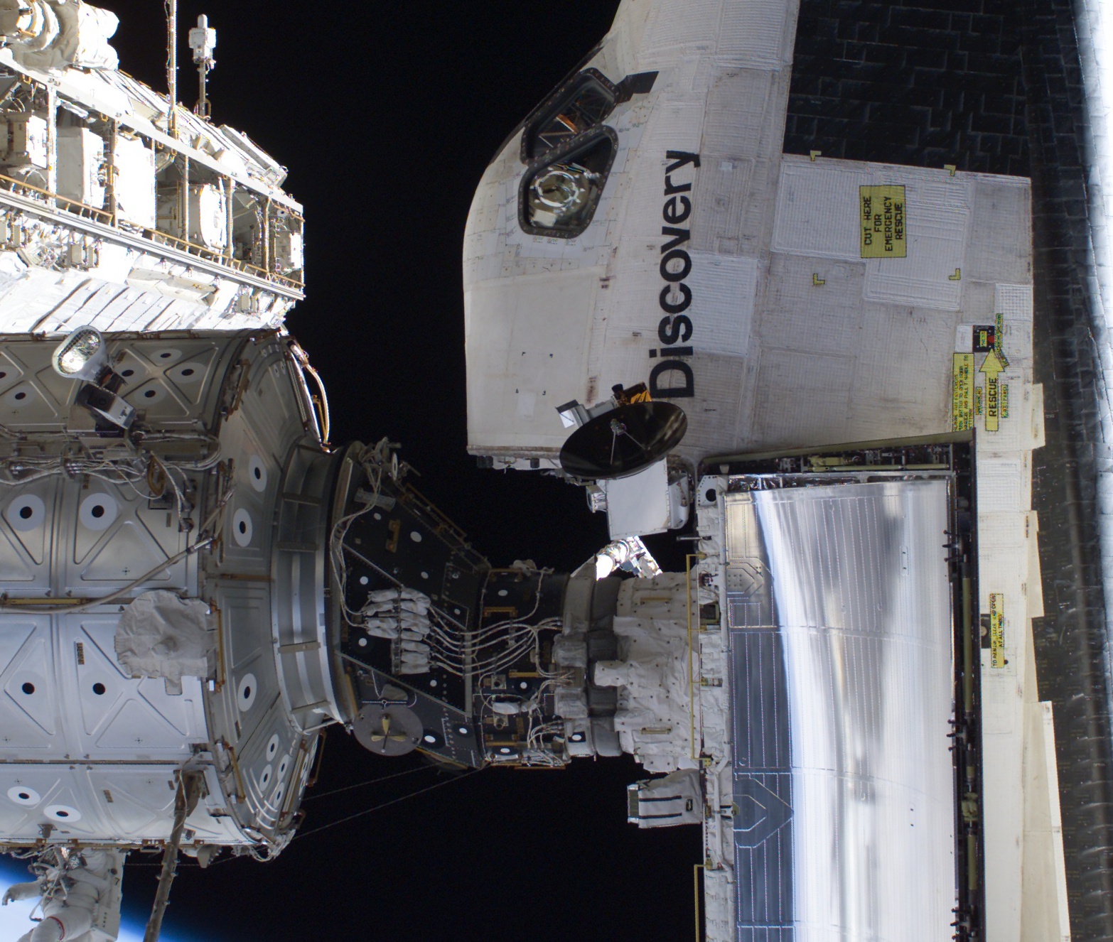 Shuttle docked at ISS via the PMA. Note the orientation dots affixed to the ISS, and the shuttle’s rendezvous radar dish next to name. (NASA archive image)